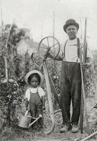 Henry Kirklin in garden with unknown child.