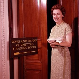 Martha Griffiths stands in front of the Ways and Means Committee Hearing Room in June 1962. [Detroit News Collection, Walter P. Reuther Library, Wayne State University]
