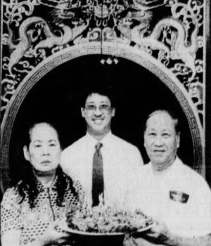 Wing Yin "David" Leong (right) poses for a photograph with his wife, Shau, and son, Ling, at the 25th anniversary of Leong's Tea House, 1988. [Springfield News-Leader, October 23, 1988, p. 1C.]